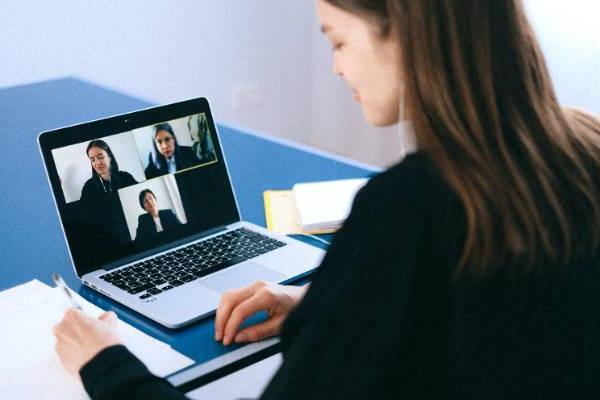 woman in front of laptop hosting a web meeting